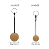 Two cork ball keyrings displayed side by side, featuring a larger 50mm model and a smaller 35mm model, both with metal rings.