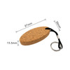 An oval cork keyring with a black cord and metal keyring attachment, measuring 87mm by 39mm.