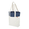 A tote bag featuring a navy blue top section and a cream-coloured lower section, with long handles and a logo.