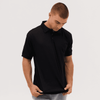 A black polo shirt displayed on a model, featuring a logo on the chest area.