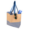 A large zipped tote bag in beige and blue, featuring sunglasses, a towel, and utensils inside.