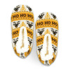 A pair of custom knitted slippers in yellow, white, and black featuring a festive pattern and a fuzzy lining.