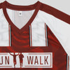 A maroon and white active V-neck T-shirt featuring a logo and dynamic design elements.