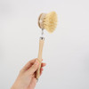 A long-handled wooden cleaning scrubber with a natural bristle head and a wooden handle.