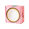 A small pink gift box with a round window and playful designs of donuts and strawberries, featuring a logo.