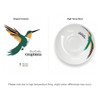 A coffee mug featuring a green and orange hummingbird design on a white background, with branding included.