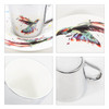 A ceramic coffee mug with a vibrant bird design and a sleek mirror-like finish, accompanied by a matching saucer.