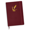 A burgundy notebook with a foil-printed logo on the cover and a matching elastic band.