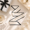 A narrow cream scarf with black edging, displayed elegantly alongside a gift box and decorative items.