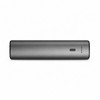 A sleek, rectangular grey power bank featuring a status indicator and a logo.