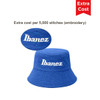 A blue reversible bucket hat featuring a logo on the front, showcasing a dual-material design.