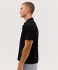 A black polo shirt displayed on a model in profile. The shirt features a collar and short sleeves.