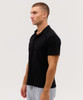 A black polo shirt displayed on a model, featuring a simple design and a classic collar.
