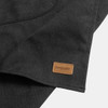 A dark grey canvas apron featuring a small leather logo tag, neatly folded to reveal texture and design.