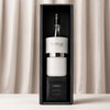 A wine bottle with a white and black cooler, placed in a stylish black and white gift box.