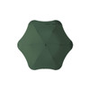 A green BLUNT Metro umbrella with a unique octagonal shape and a central button for opening and closing.