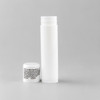 A white lip balm container and a small white cap, featuring an unobtrusive logo.