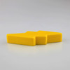 A yellow stress relief toy shaped like a lightning bolt, with a smooth, solid design.
