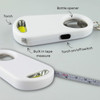 A drink bottle opener key ring in white with a built-in torch and tape measure, featuring a logo.