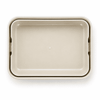 A light beige rectangular lunchbox with a smooth surface and rounded edges. It features a logo.