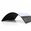 A flip-top mouse mat in black and white, with a textured underside, showcasing a curved profile.