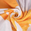 A gym towel featuring a swirl pattern in vibrant shades of orange and white, with a branded logo present.