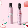 A pink umbrella with a peach design, displayed both open and in its case, featuring a black handle and branding.