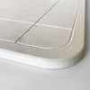A light grey bath mat with a smooth texture and rounded edges, featuring subtle design lines. It has a branding logo.