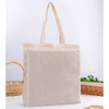 A neutral-coloured tote bag with gusset and two handles, featuring a simple design and a logo.