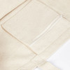 A cream-coloured canvas tote bag featuring a zippered pocket on the front. It has a simple, unembellished design.