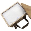 A square wicker picnic cooler basket with a light-coloured interior and brown straps, partially open.
