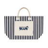 A striped navy and cream tote bag featuring a front pocket and handles, with a logo on the pocket.