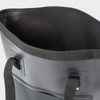 A black bucket bag with a smooth, rounded edge and side handles, featuring a sleek, minimalistic design.