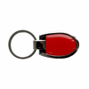 A shiny silver keychain featuring a red shield-shaped design with a metal loop for attaching keys.