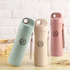 A drink bottle collection featuring green, pink, and beige wheat straw bottles with a logo and strap.