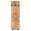 A drink bottle with a bamboo exterior and a silver stainless steel interior features a circular logo design.