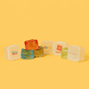 Jelly Cube sensory toys in various colours, featuring a promotional logo on one cube against a bright yellow background.