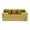A bamboo perpetual calendar featuring cubed date and month blocks in a natural wood holder.
