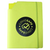 A bright yellow leatherette notebook cover with a black circular logo on the front. It features a pocket for documents.