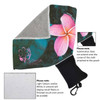 A microfibre towel in teal with a floral design, accompanied by a black pouch for storage.