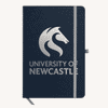 A navy A5 notebook with a branded logo on the cover and an elastic band closure.