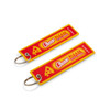 A vibrant red and yellow woven keytag featuring pizza graphics and a logo, attached to a metal keyring.