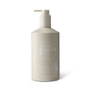 A hand and body wash in a beige pump bottle with a logo, featuring sea salt and pearl extract.