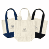 Three mini canvas tote bags in natural, navy blue, and black with various logos on the front.