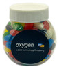 A plastic jar filled with colourful mini jelly beans, featuring a white lid and a logo on the front.