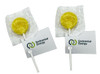 Yellow lollipops wrapped in clear plastic with a white stick and attached tags featuring branding.