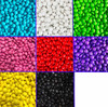 A collection of choc beans in various colours, including blue, white, green, pink, red, purple, black, and yellow.