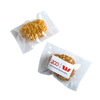 Two individually wrapped protein balls coated in crushed nuts, featuring a simple logo on the packaging.