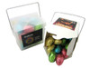 A noodle box containing colourful Easter eggs, including shades of pink, blue, gold, and green. The box has a handle and a logo.