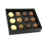 A black box containing twelve assorted chocolate truffles in various flavours, including white and dark chocolate.